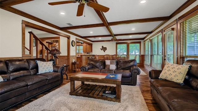 living room featuring visible vents, beamed ceiling, a wainscoted wall, wood finished floors, and coffered ceiling