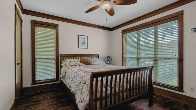 bedroom featuring a ceiling fan, crown molding, baseboards, and wood finished floors