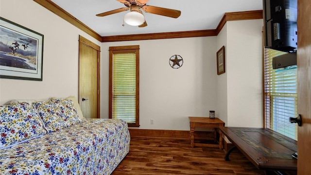 bedroom featuring crown molding, wood finished floors, baseboards, and ceiling fan