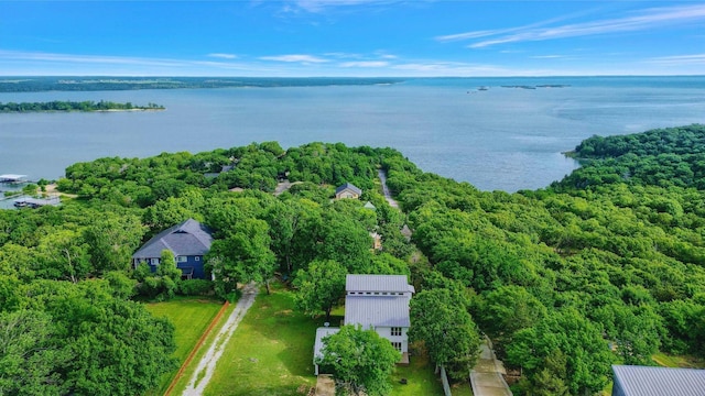 drone / aerial view with a forest view and a water view