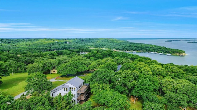 aerial view with a wooded view and a water view