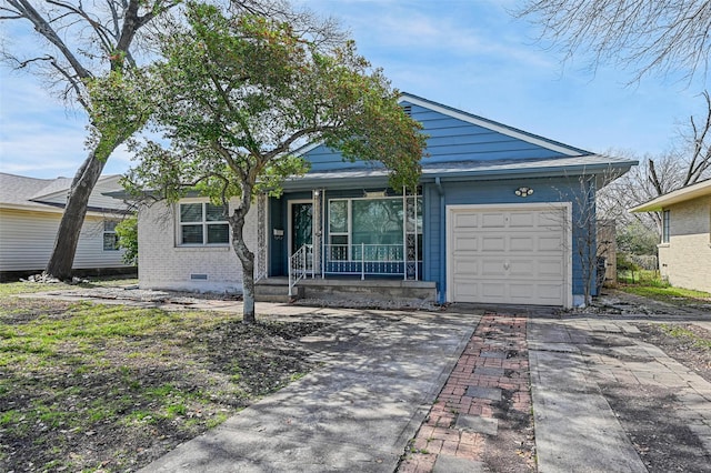 ranch-style home featuring brick siding, concrete driveway, covered porch, a garage, and crawl space