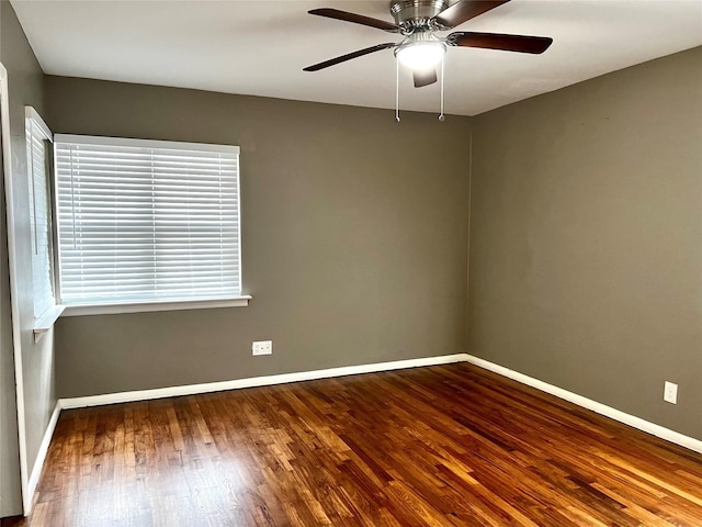 empty room featuring a ceiling fan, wood finished floors, and baseboards