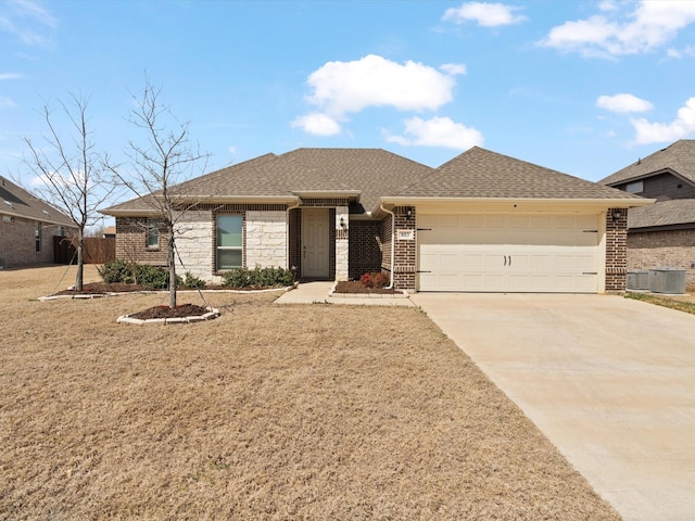 view of front of house with brick siding, concrete driveway, a garage, and roof with shingles