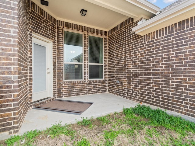 doorway to property with brick siding