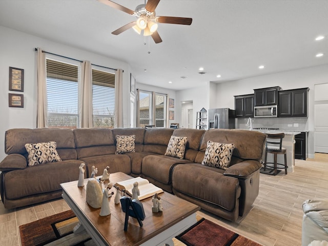 living area with recessed lighting, a ceiling fan, and wood tiled floor