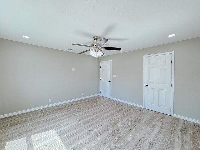 unfurnished room with a ceiling fan, baseboards, visible vents, light wood-style flooring, and recessed lighting