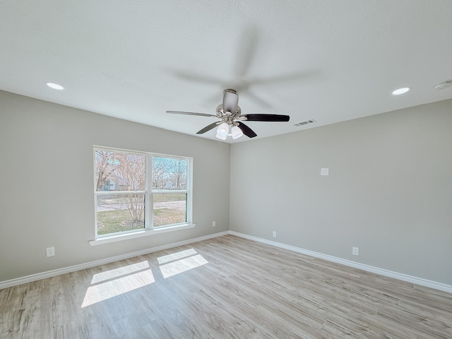 unfurnished room with recessed lighting, visible vents, light wood-style flooring, and baseboards