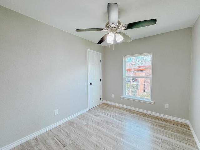 unfurnished room featuring baseboards, light wood-style flooring, and a ceiling fan