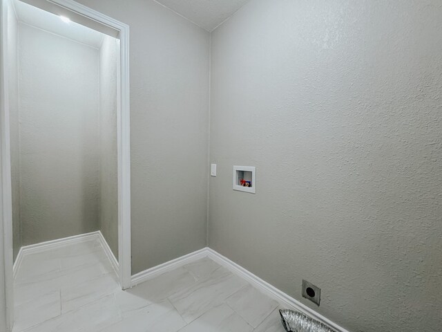 laundry area featuring baseboards, laundry area, hookup for a washing machine, marble finish floor, and electric dryer hookup