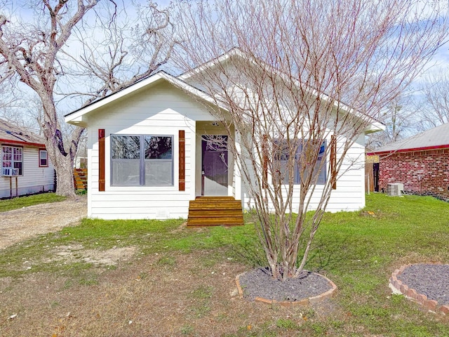 bungalow-style house with entry steps, a front lawn, and central AC unit