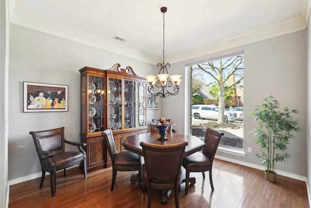 dining room with a chandelier, visible vents, baseboards, and wood finished floors