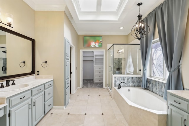 bathroom with tile patterned flooring, a shower stall, crown molding, a walk in closet, and a garden tub