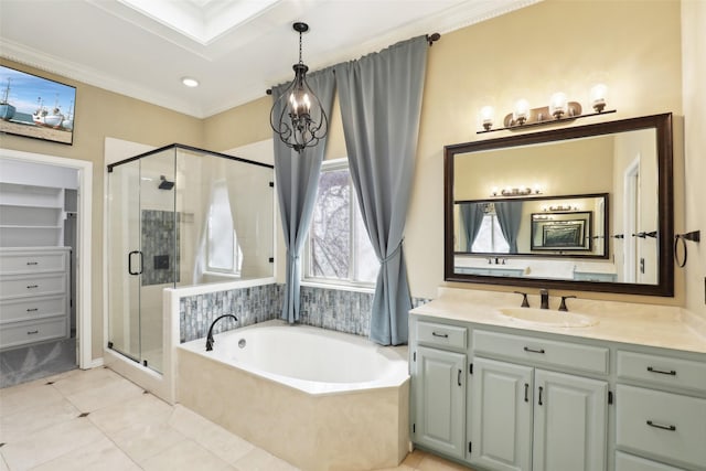 bathroom featuring tile patterned flooring, ornamental molding, a stall shower, a bath, and vanity