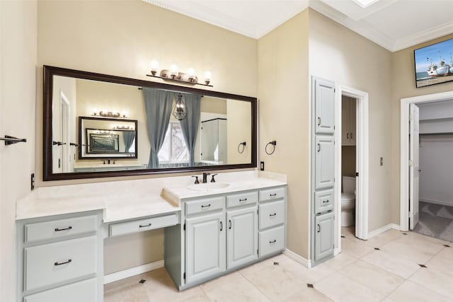 bathroom featuring toilet, ornamental molding, vanity, and tile patterned flooring