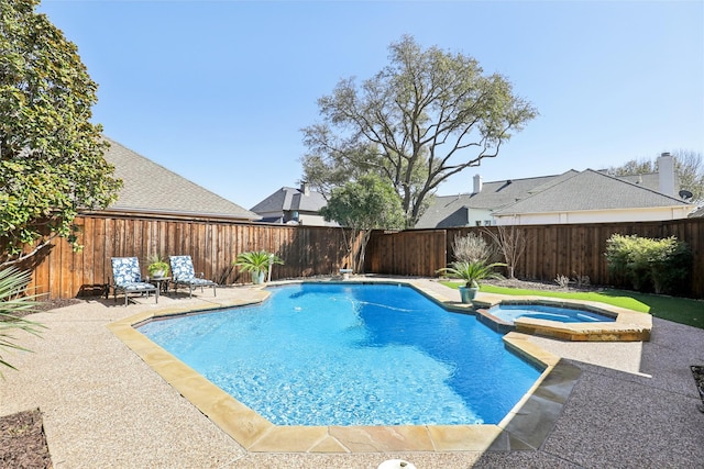 view of swimming pool with a patio, a fenced backyard, and a pool with connected hot tub