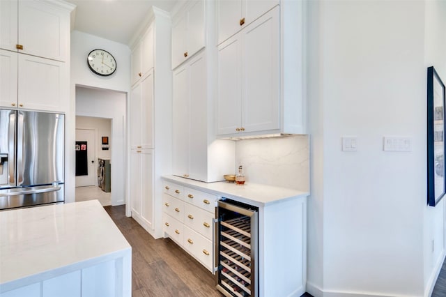 kitchen featuring wine cooler, decorative backsplash, white cabinets, and stainless steel fridge with ice dispenser