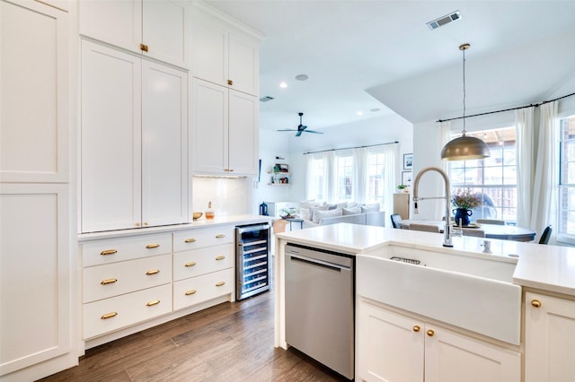 kitchen featuring visible vents, a sink, light countertops, wine cooler, and dishwasher