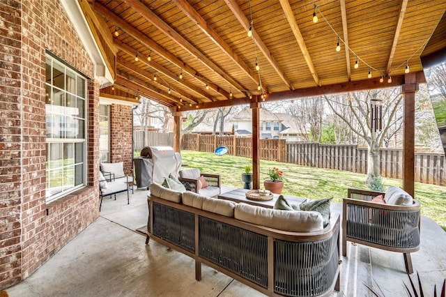 view of patio / terrace with grilling area, an outdoor living space, and a fenced backyard