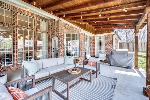 view of patio / terrace with area for grilling, outdoor lounge area, and fence