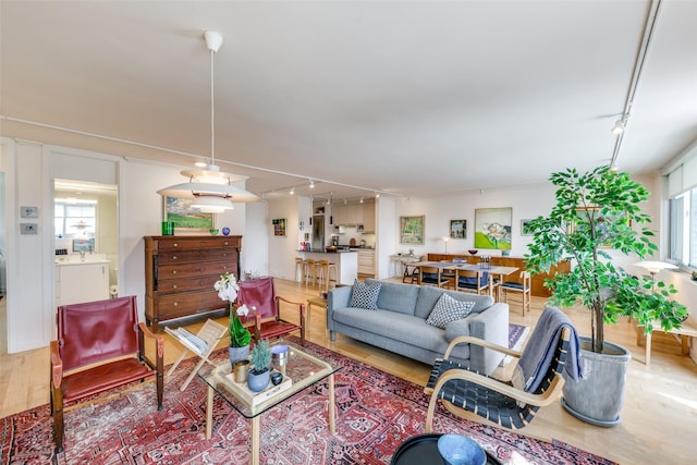 3883 Turtle Creek Blvd Unit 2214, Dallas, TX 75219 - living room featuring track lighting, wood finished floors, and healthy amount of natural light