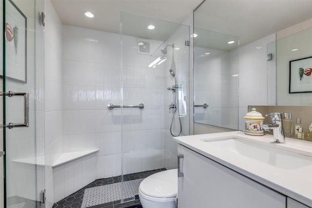3883 Turtle Creek Blvd Unit 2214, Dallas, TX 75219 - full bathroom with vanity, toilet, a stall shower, tile walls, and recessed lighting
