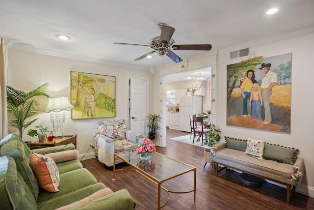 living room featuring visible vents, wood finished floors, ceiling fan, and ornamental molding