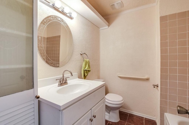 bathroom with vanity, visible vents, tile patterned flooring, toilet, and a textured wall