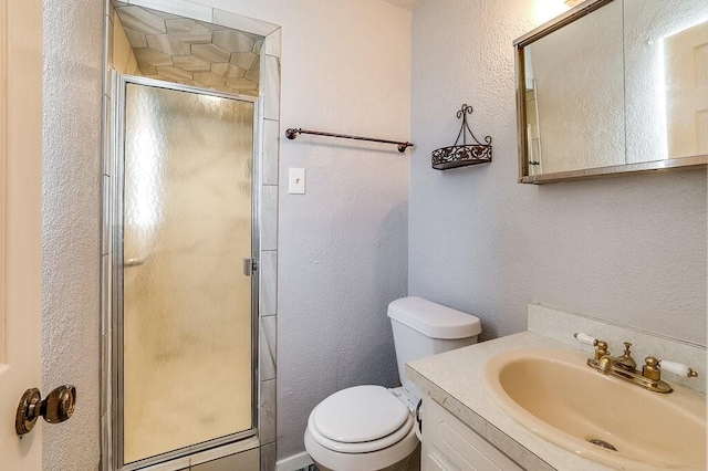 full bath featuring a shower stall, toilet, vanity, and a textured wall