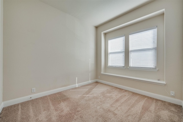 empty room with baseboards and light carpet