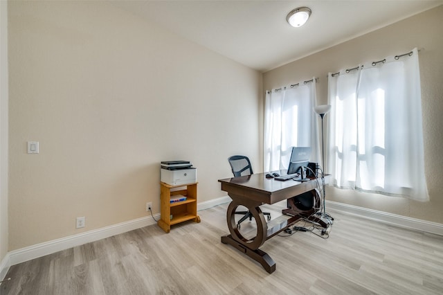 office with light wood-style flooring and baseboards