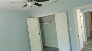 unfurnished bedroom with a closet and ceiling fan