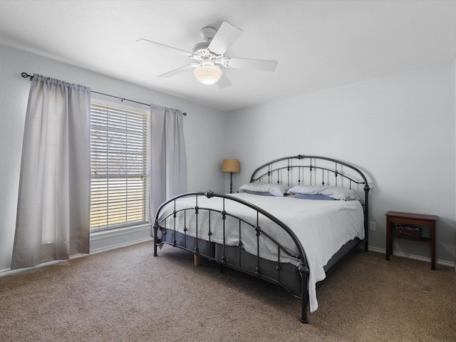 bedroom featuring baseboards, carpet floors, and a ceiling fan