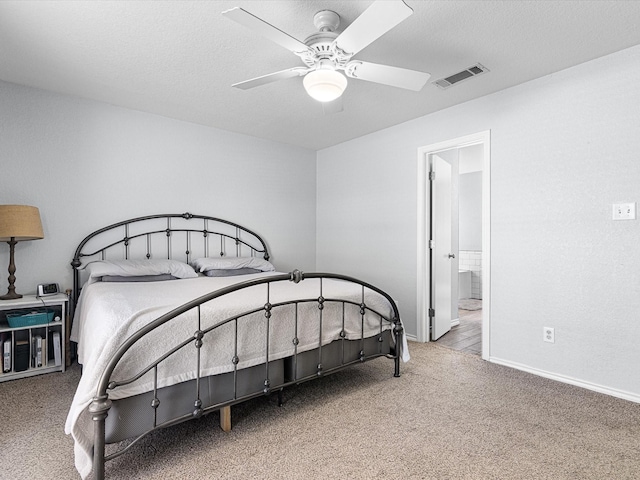 carpeted bedroom featuring visible vents, baseboards, a textured ceiling, and ceiling fan