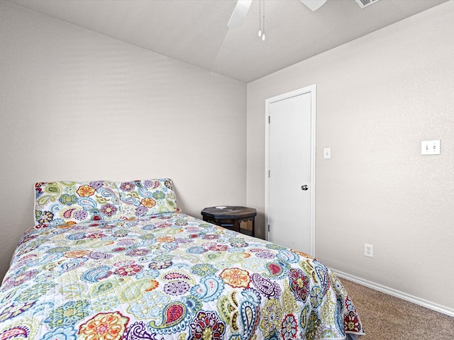 carpeted bedroom with baseboards, ceiling fan, and vaulted ceiling