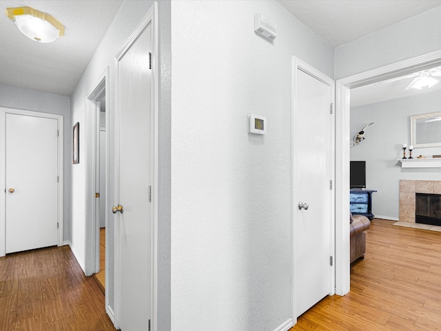 hallway featuring baseboards and light wood-type flooring