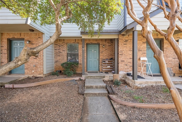 entrance to property with brick siding