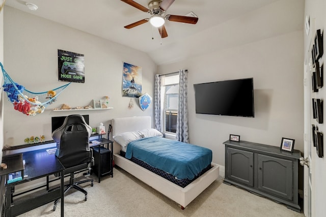 bedroom with a ceiling fan, vaulted ceiling, and light colored carpet