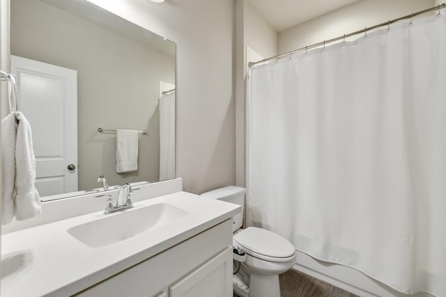 full bath with vanity, toilet, and wood finished floors