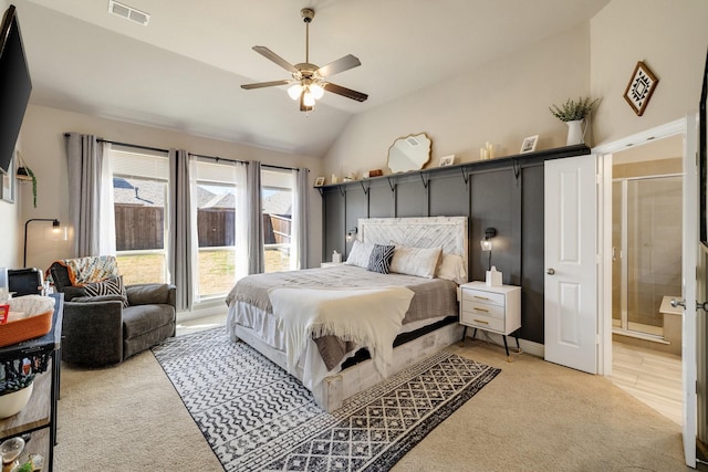 bedroom with vaulted ceiling, connected bathroom, visible vents, and light carpet