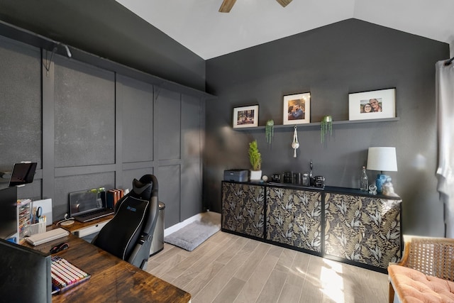 office space with lofted ceiling, wood finished floors, and ceiling fan