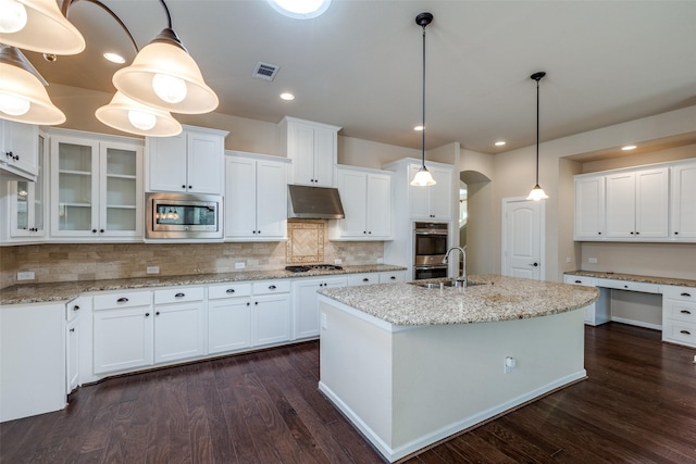 kitchen with under cabinet range hood, visible vents, white cabinetry, and stainless steel appliances