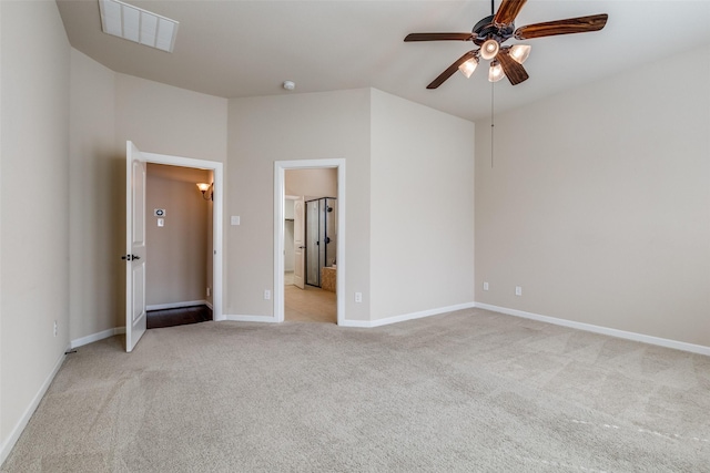 unfurnished bedroom with visible vents, light carpet, a ceiling fan, ensuite bath, and baseboards