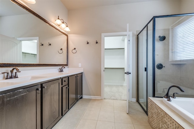 full bath with a spacious closet, a shower stall, and a sink