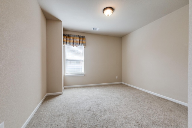 unfurnished room with visible vents, carpet, and baseboards