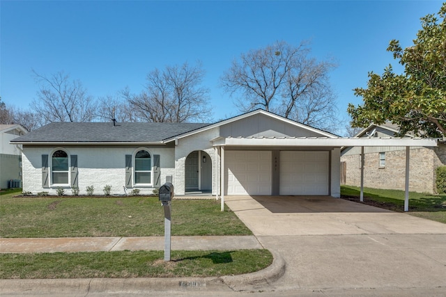 view of front facade with driveway, an attached garage, central AC, a front lawn, and brick siding