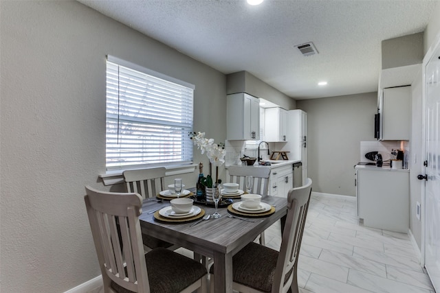 dining area featuring visible vents, baseboards, a textured wall, marble finish floor, and a textured ceiling