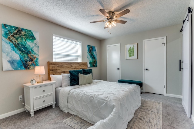 bedroom featuring a textured ceiling, a ceiling fan, baseboards, and light carpet