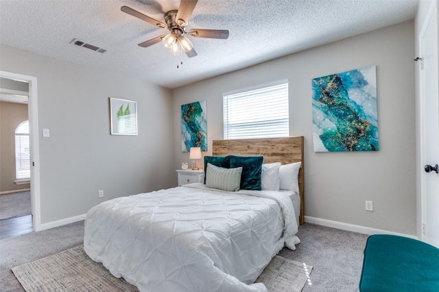 bedroom featuring multiple windows, carpet, visible vents, and baseboards