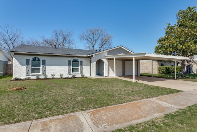 view of front of home with driveway, a front yard, a garage, an attached carport, and brick siding